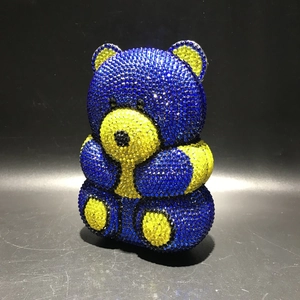 Detail of luxury teddy bear clutch bag with blue and yellow rhinestone encrusted crystals