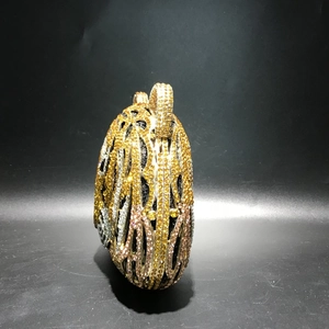 Detail of tiger head evening bag showing intricate hollow metal design and colorful rhinestones