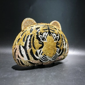 Close-up of luxury tiger head evening bag with yellow and black crystal rhinestones