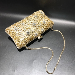 Golden hollow floral evening bag with sparkling crystals and a fine metal chain