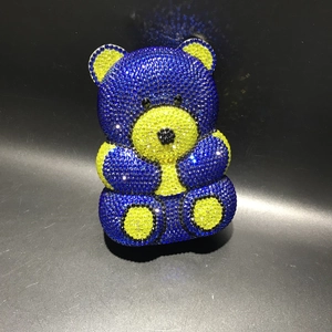 Detail view of blue and yellow crystal encrusted teddy bear clutch bag for evening
