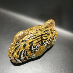 Detailed view of handmade tiger head evening bag with sparkling gold and black crystals