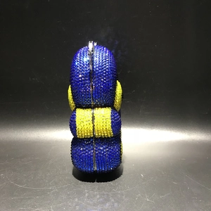 Detailed view of handmade crystal-encrusted cartoon minion evening clutch bag
