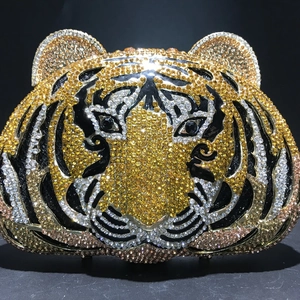 Detailed view of luxury tiger head evening clutch bag featuring intricate crystal rhinestones