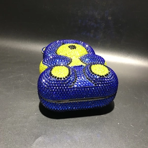 Detailed view of luxury bear evening bag with blue and yellow sparkling rhinestones