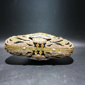 Detailed top view of tiger-head evening bag with hand-set crystals and gold metal frame