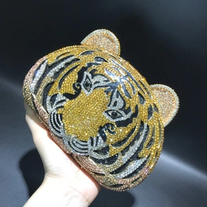 Detailed view of luxury tiger head evening clutch bag with handcrafted rhinestones
