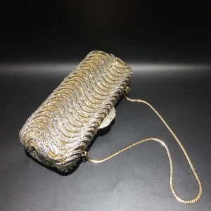 Sparkling crystal evening clutch bag with wavy rhinestone pattern and gold chain strap