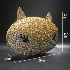 Close-up of golden fox evening bag with dense rhinestone pavé and crystal inlay details