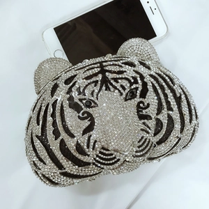 Detailed view of luxury tiger-shaped evening clutch bag encrusted with crystals