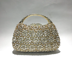 Detailansicht der goldenen Blumen-Clutch mit glitzernden Strasssteinen und Metallgriff