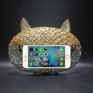 Detail view of fox crystal evening bag showing its capacity compared to an iPhone 6s