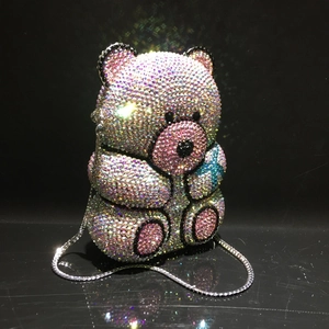 Detailed view of shimmering rhinestone bear evening clutch with silver chain strap