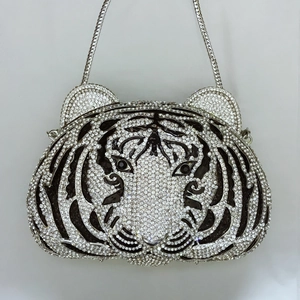 Detailed view of luxury tiger head evening bag with sparkling black and white rhinestones