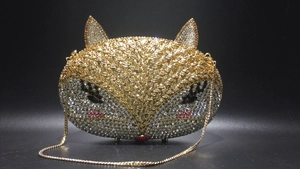 Detailed close-up of a fox-shaped evening clutch bag with handmade colorful rhinestones