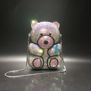 Detail of bear-shaped handbag with pink and blue crystal rhinestones and chain