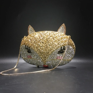 Detailed view of fox-shaped evening clutch bag with sparkling crystals and golden chain