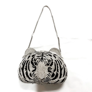 Detail of tiger head evening bag with sparkling rhinestones and silver chain strap