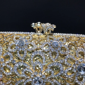 Luxury gold hollow metal clutch bag with sparkling crystals and floral rhinestone patterns