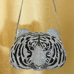 Macro shot of tiger head evening clutch featuring black and white crystal rhinestones