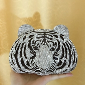 Detail shot of tiger-shaped evening bag with shimmering crystals and black stripes