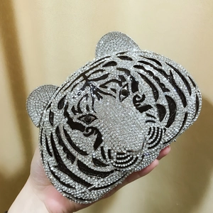 Macro detail of tiger head evening bag showing hand-set silver rhinestones and intricate patterns