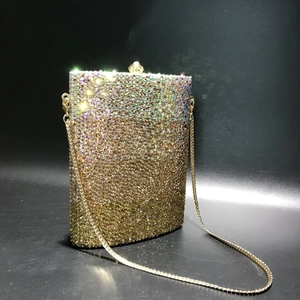 Detail of crystal evening bag with golden gradient rhinestones and gold chain strap