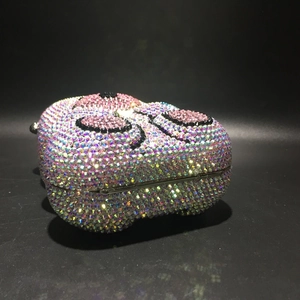 Macro detail of the sparkling pink crystal bear evening bag with its metal frame and clasp