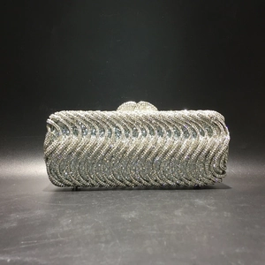 Detailed view of silver wavy rhinestone evening bag with sparkling crystal embellishments