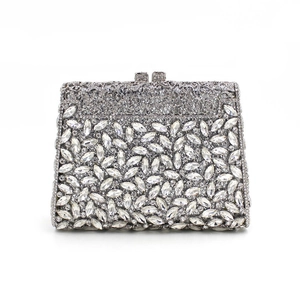 Macro shot of silver evening clutch bag with sparkling marquise and round rhinestones