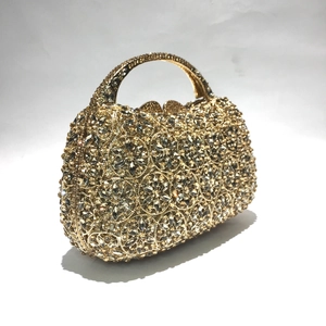 Makro-Detail der Luxus-Abendtasche in Gold mit aufwendigem Strass-Blumenmuster