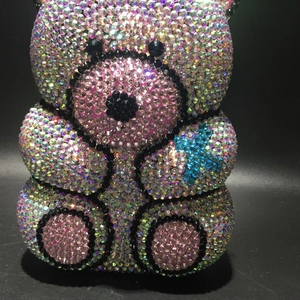 Macro shot of luxury bear evening bag with sparkling AB pink rhinestones and black details