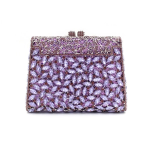 Detail of purple rhinestone clutch showing intricate silver hollow metalwork and crystals