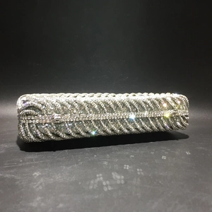 Detailed view of handmade sparkling rhinestones and silver metal clasp on evening clutch