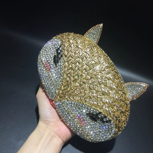 Close-up of luxury fox-shaped evening clutch bag with sparkling gold and silver rhinestones