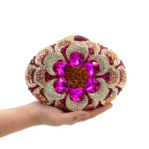 Detailed close-up of a flower-shaped evening clutch bag with colorful crystals and rhinestones