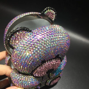 Detailed close-up of a sparkling bear-shaped clutch bag with colorful rhinestones