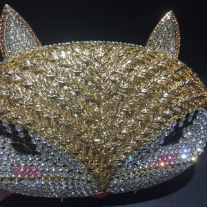 Macro shot of handcrafted fox head evening bag with sparkling crystal rhinestones