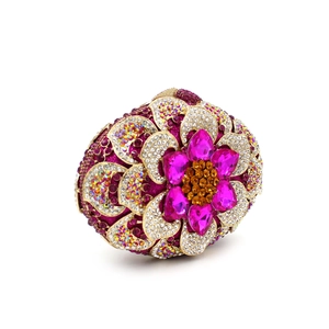 Macro detail of luxury rhinestone clutch featuring intricate floral patterns and gold frame