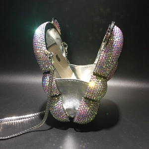 Detail showing the internal capacity of the crystal bear clutch with a smartphone