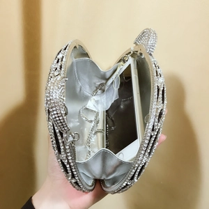 Detailed view showing internal capacity of the silver tiger head rhinestone evening clutch bag