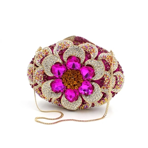 Close-up of luxury floral clutch with pink heart gems and intricate rhinestone detailing