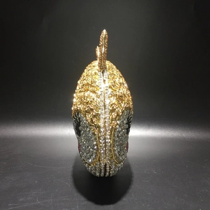 Detailed view of handmade fish-shaped evening bag featuring intricate rhinestone inlay