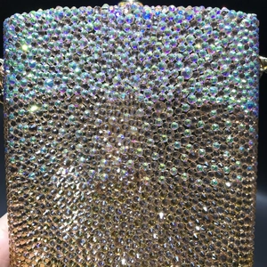 Close-up of luxury gradient crystal clutch bag with vibrant blue and gold rhinestones