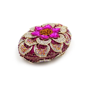 Macro detail of floral evening clutch featuring pink crystals and rhinestone petals