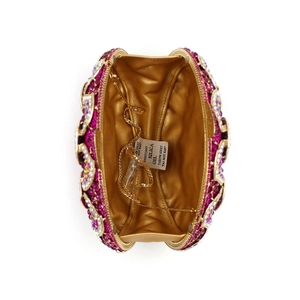 Detail of evening clutch featuring rose red rhinestones, gold satin lining, and chain strap