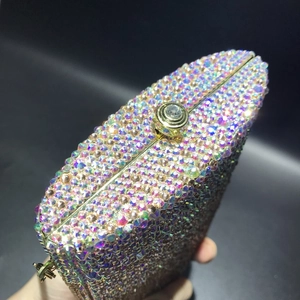 Macro detail of luxury crystal evening clutch featuring colorful rhinestones and gold clasp