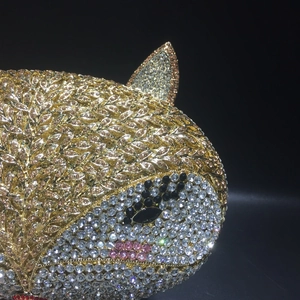 Macro shot of detailed crystal inlay and hollow metal craftsmanship on animal evening bag