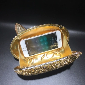 Detail view of fox ear crystal evening clutch bag capacity with a smartphone and gold chain