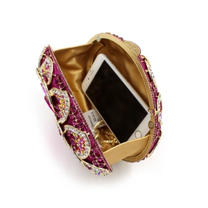 Detail view of the open rhinestones clutch bag showing purple gems and golden lining